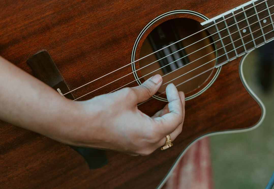 female musician playing guitar