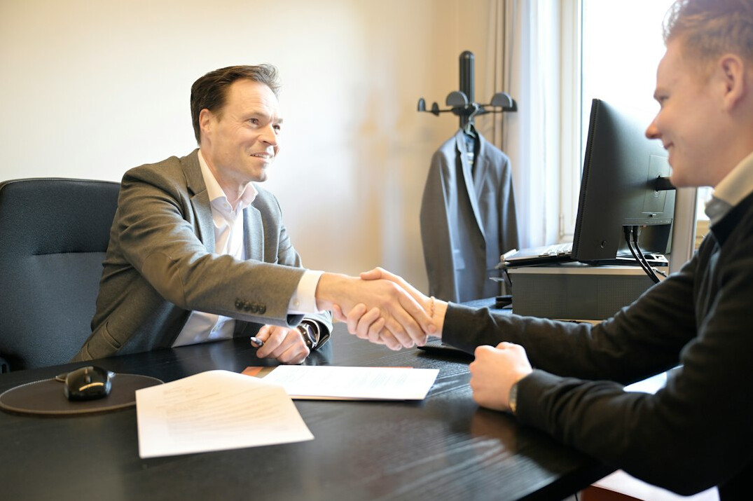 businessman handing over check